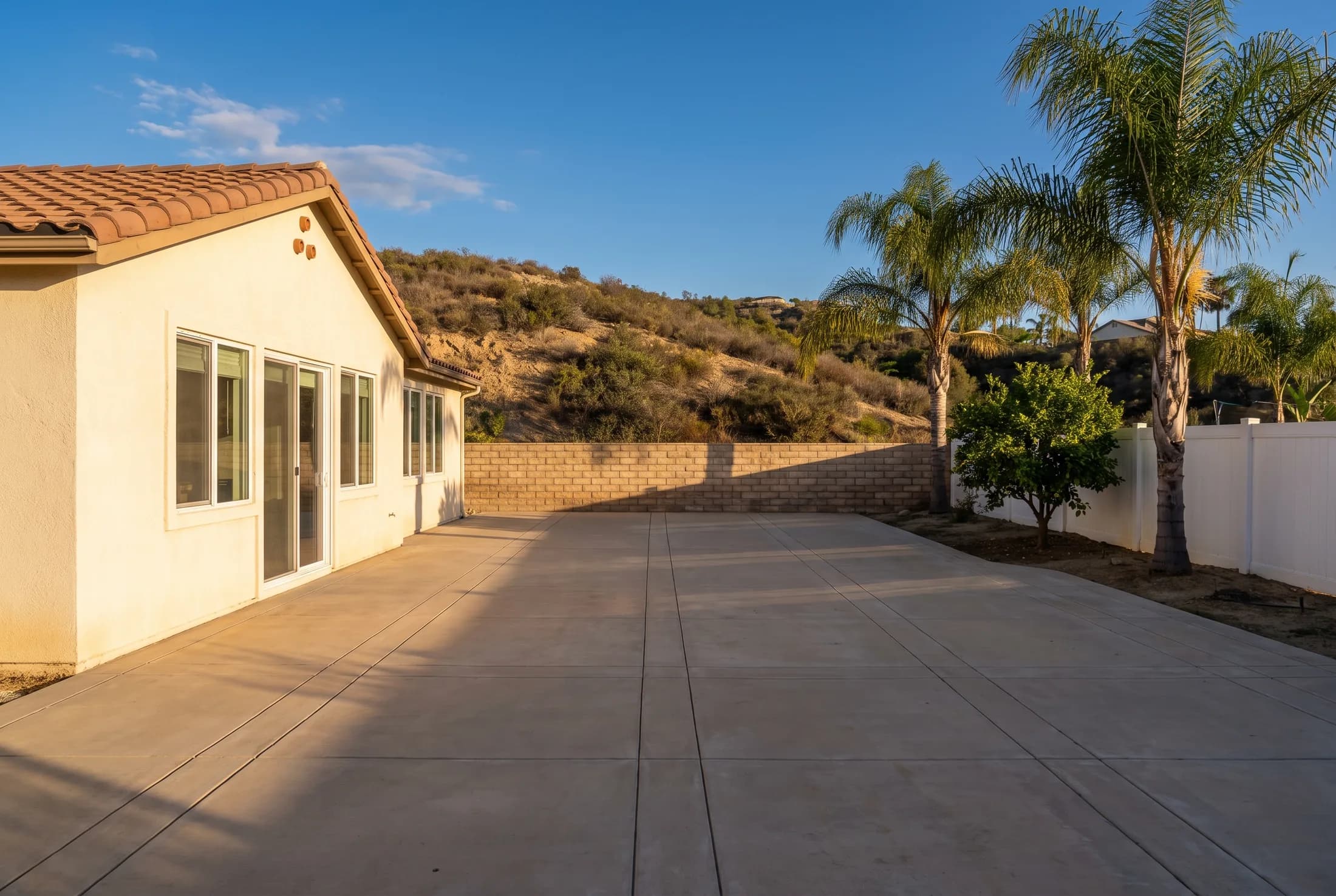 A bare concrete patio behind a San Diego County home with nothing built on it