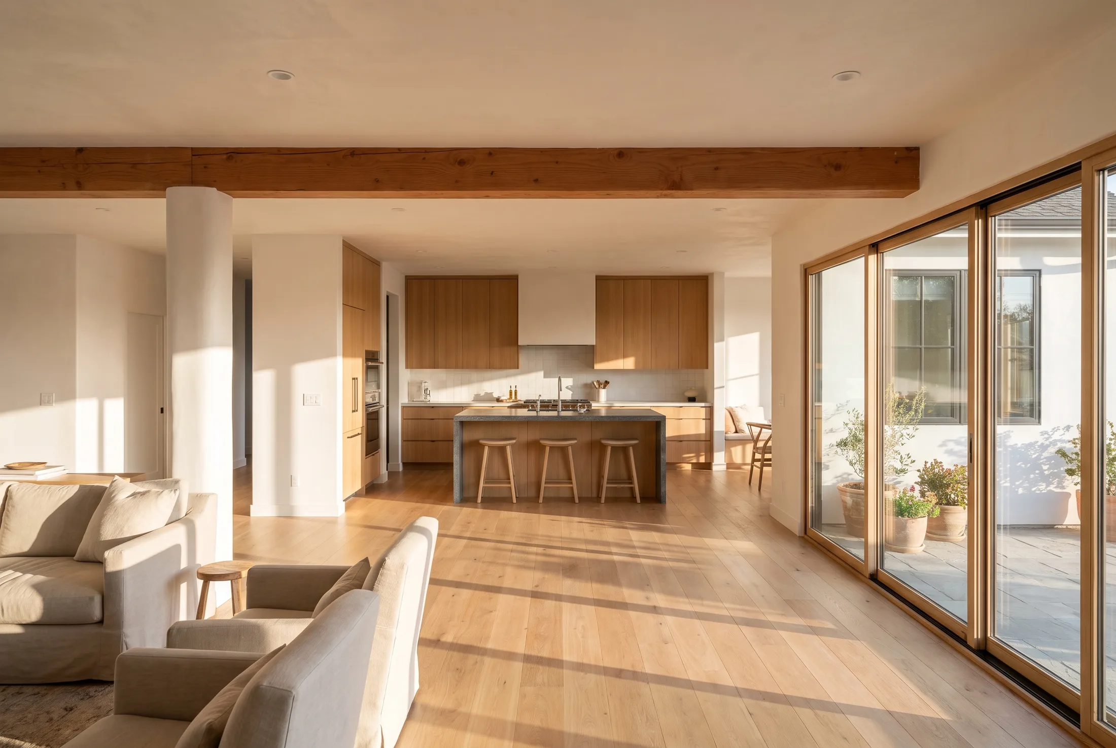 Open-concept living room and kitchen with an exposed beam carrying the load where a wall was removed