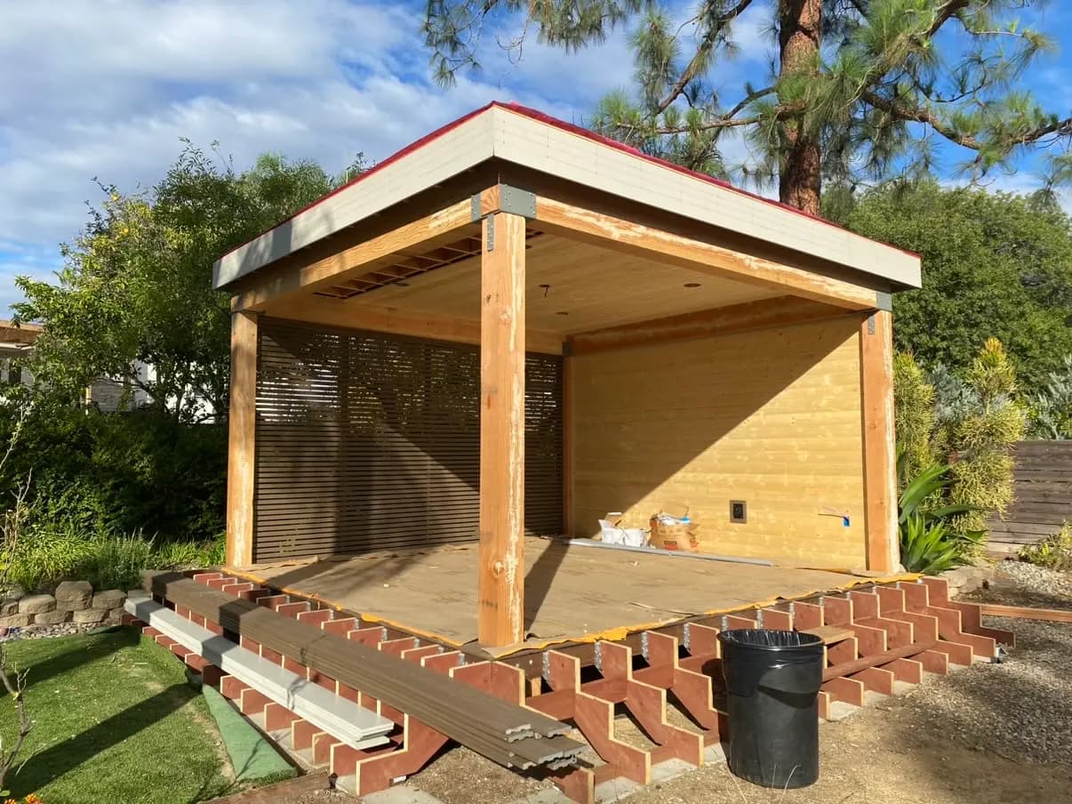Cedar pavilion and deck with wide stairs stepping down to the lawn in Rancho Bernardo